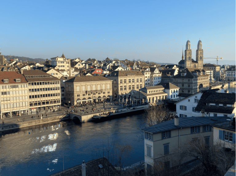 Splendid view of Limmatquai in Zurich with the iconic Grossmünster Church, one of the must-see landmarks for anyone exploring things to see in Zurich in one day.