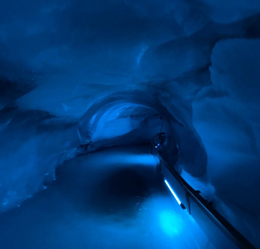 Inside the icy, blue-hued Glacier Cave Tunnel on Mount Titlis.