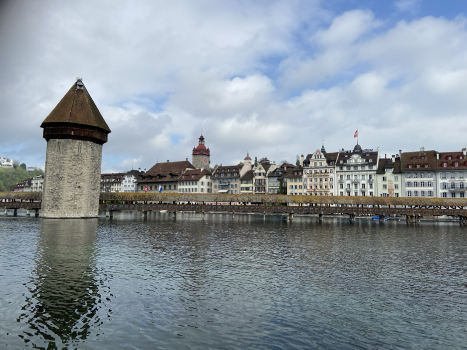 Lucerne's iconic Chapel Bridge and Water Tower on the Reuss River, set against a backdrop of traditional Old Town houses. 