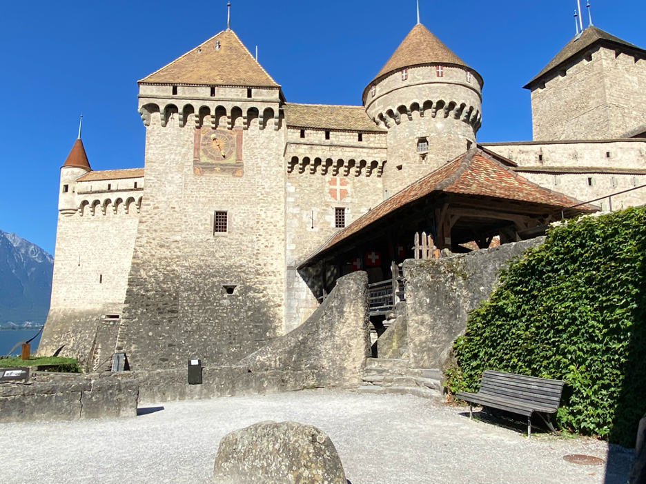 Chillon Castle in Montreux under a bright blue sky, showcasing its majestic medieval architecture.