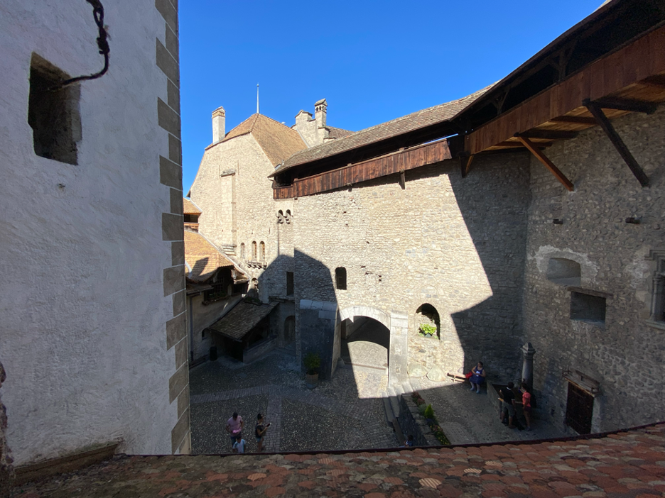 One of Chillon Castle’s charming courtyards with wooden covered walkways above.