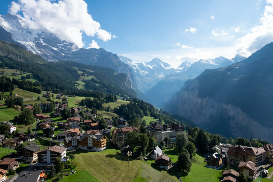 A picturesque view of Wengen, a car-free mountain resort perched in the Jungfrau Region of the Bernese Oberland, surrounded by lush alpine scenery.