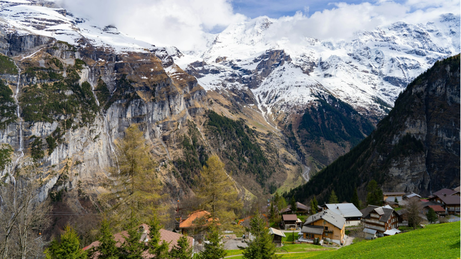 A stunning view of Mürren, a peaceful car-free mountain resort in the Jungfrau Region of the Bernese Oberland, with its dramatic alpine backdrop.