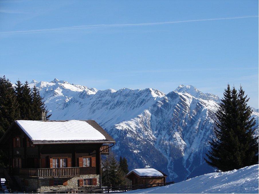 A traditional chalet in Riederalp, surrounded by a winter wonderland of snow, showcasing the charm of this car-free mountain resort in Switzerland.