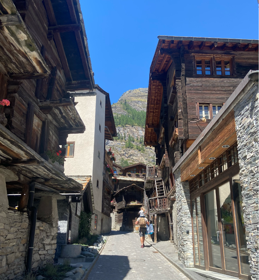 Traditional wooden houses line the streets of the old part of Zermatt, one of the most charming car-free mountain resorts in the Swiss Alps. 