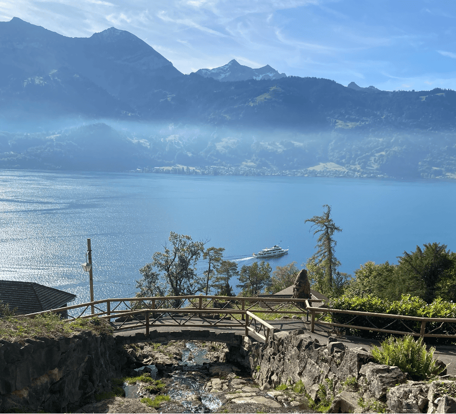 View from St. Beatus Caves down onto Lake Thun with a boat departing.