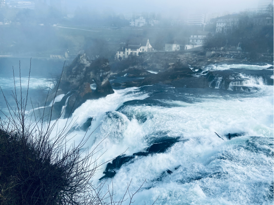 Close-up view of the powerful Rhine Falls from Laufen Castle, capturing the rushing water and misty spray of Europe's largest waterfall.