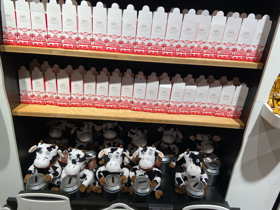 The interior of the Cailler Chocolate Factory store in Broc, showcasing a variety of Swiss chocolates available for purchase, with shelves filled with beautifully packaged treats.