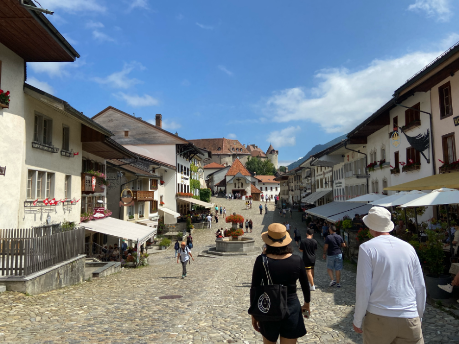 The charming historic town of Gruyères, Switzerland, featuring cobbled streets and picturesque houses with traditional Swiss architecture.