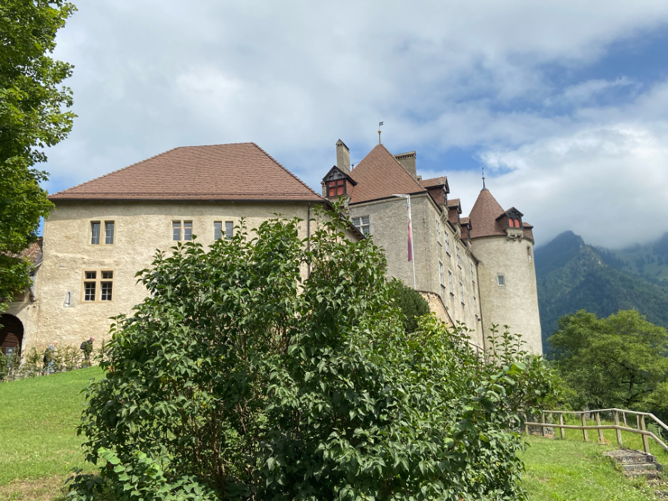 A majestic view of Gruyères Castle, perched on a hill, with its medieval towers and historic charm.