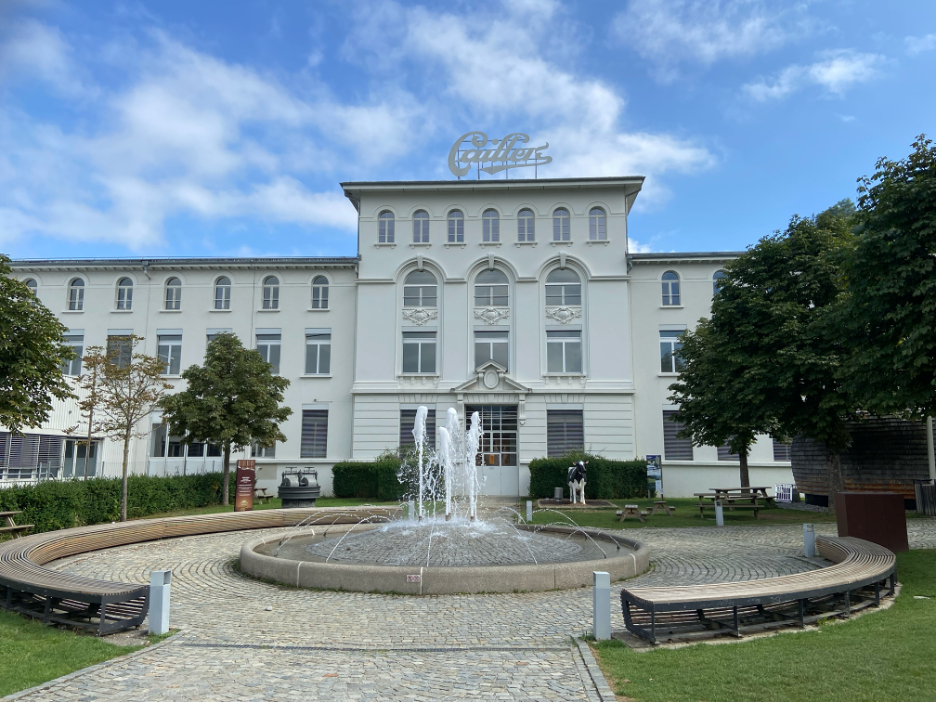 The exterior of the Cailler Chocolate Factory in Broc, Switzerland, known for its delicious Swiss chocolate and rich history. It is also a key destination along the Swiss Chocolate Train Tour.