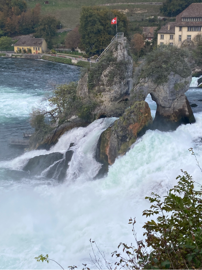 Rhine Falls rock island, a striking formation in the middle of the falls that can be explored via a Rhine Falls Cruise.