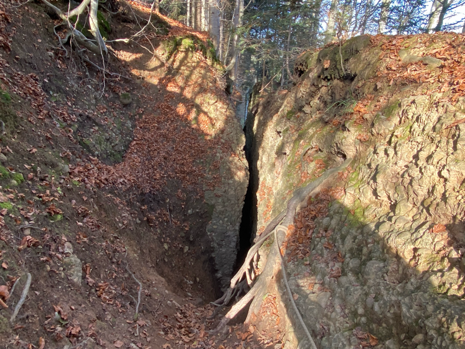 A dramatic view looking down Bachtelspalt, a narrow rock crevice that adds an adventurous twist to one of the best hikes near Zurich.