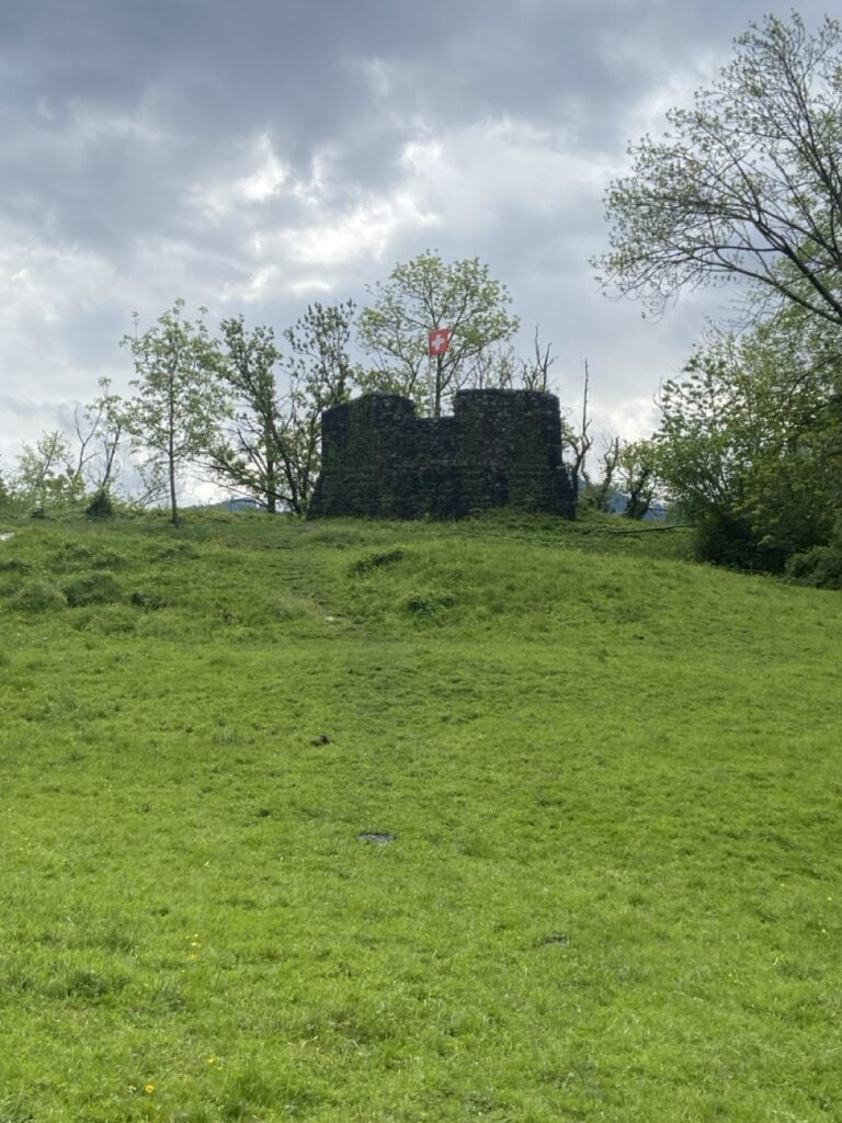 Strahlegg ruins on green hillside above Lake Walensee
