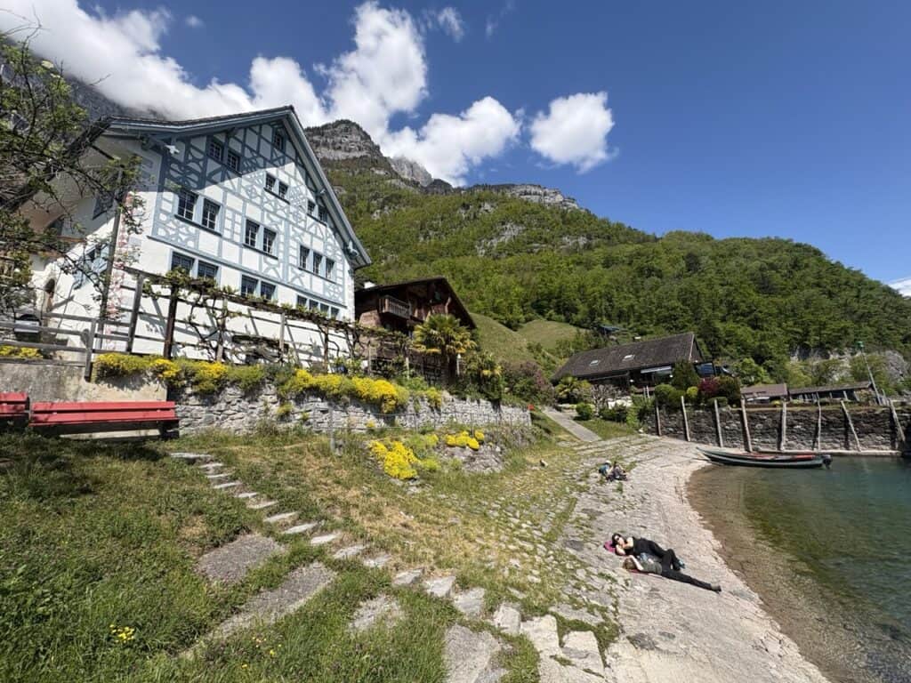 People relaxing along the waterfront in the lakeside village of Quinten