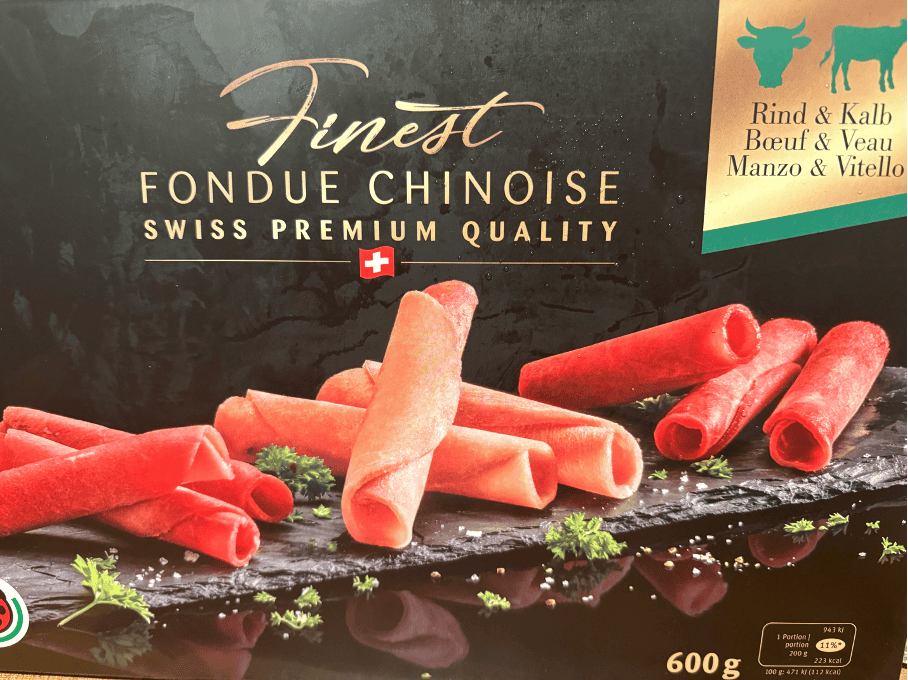 Supermarket package of thinly sliced rolled frozen veal and beef for Fondue Chinoise, a Swiss meat fondue. 