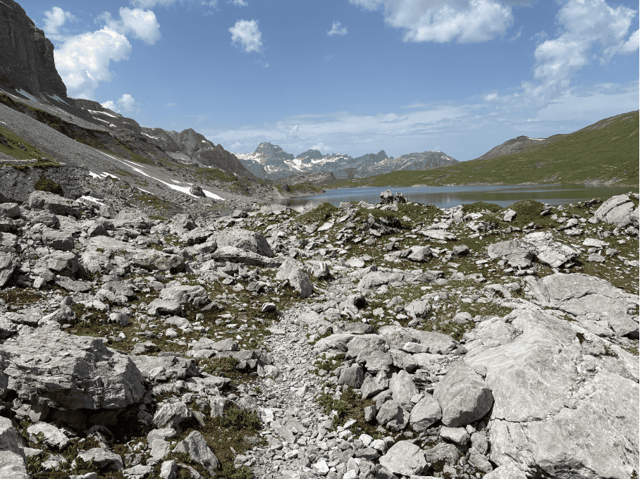arrow rocky hiking path along Glattalpsee, a beautiful mountain lake in Central Switzerland