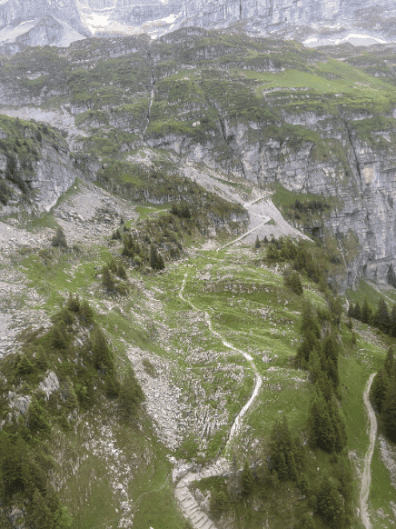 Narrow hiking trail curving up the mountain to Glattalp in Central Switzerland