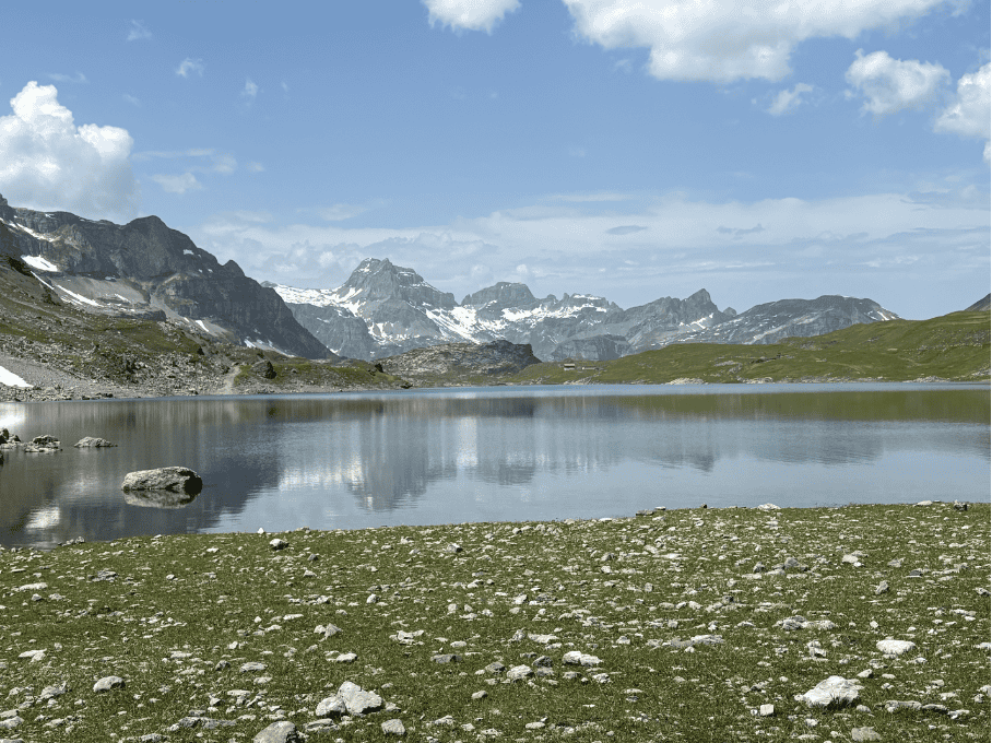 Mountain peaks reflecting in the clear waters of Glattalpsee, Swiss mountain lake in Central Switzerland