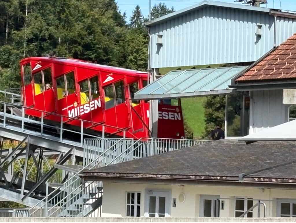 Red Niesen funicular at the Mülenen valley station, beginning the climb up Mount Niesen.