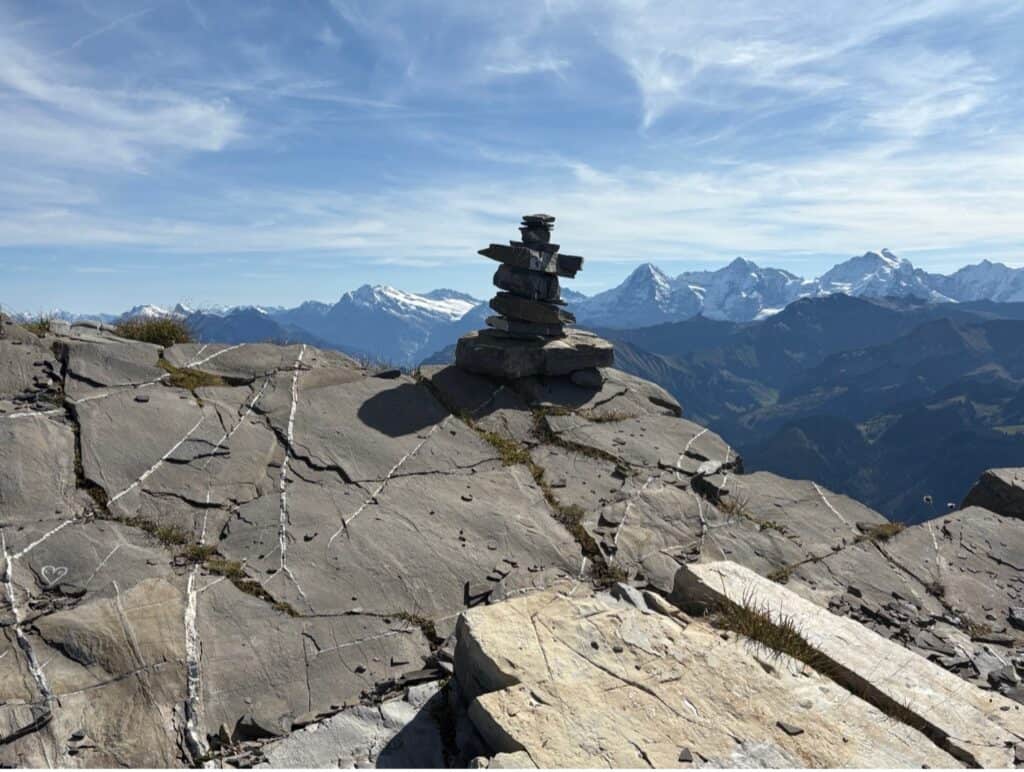Rock formation on Mount Niesen with snow-covered Alpine peaks in the background