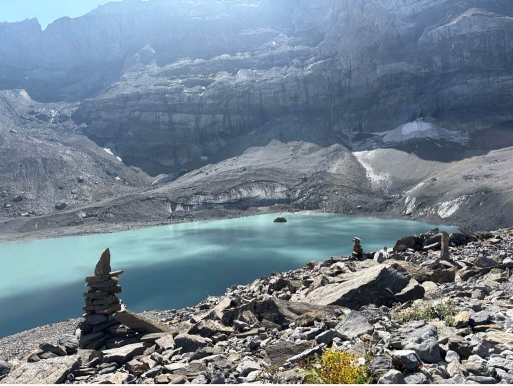 Turquoise blue Gletscherseeli, a beautiful Swiss mountain lake surrounded by rocky alpine terrain, can be reached on one of the best short hikes in Switzerland.