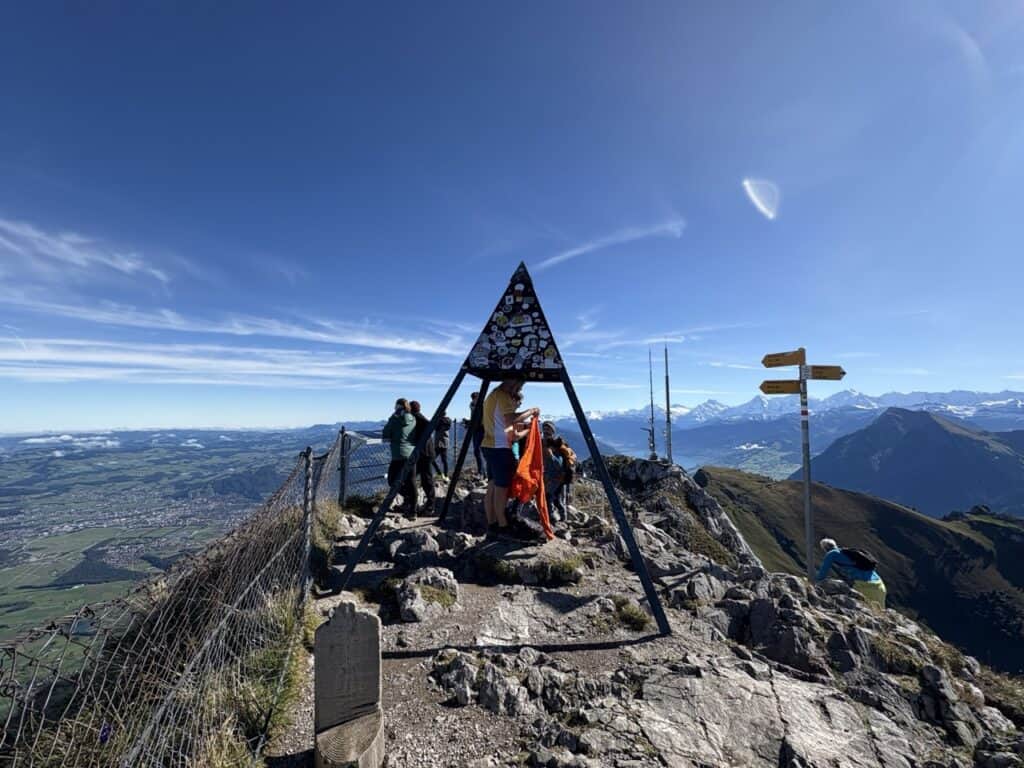Pyramid-shaped summit marker on Stockhorn offering sweeping panoramic views.