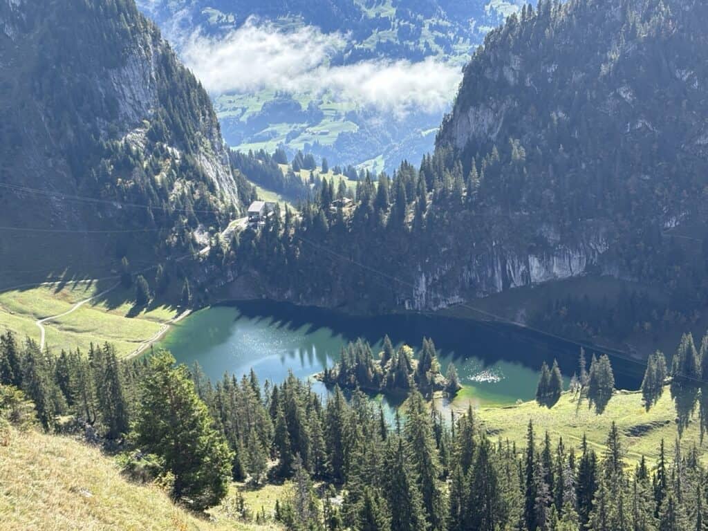 Aerial view of emerald-green Hinterstockensee lake, one of the most beautiful mountain lakes in Switzerland.
