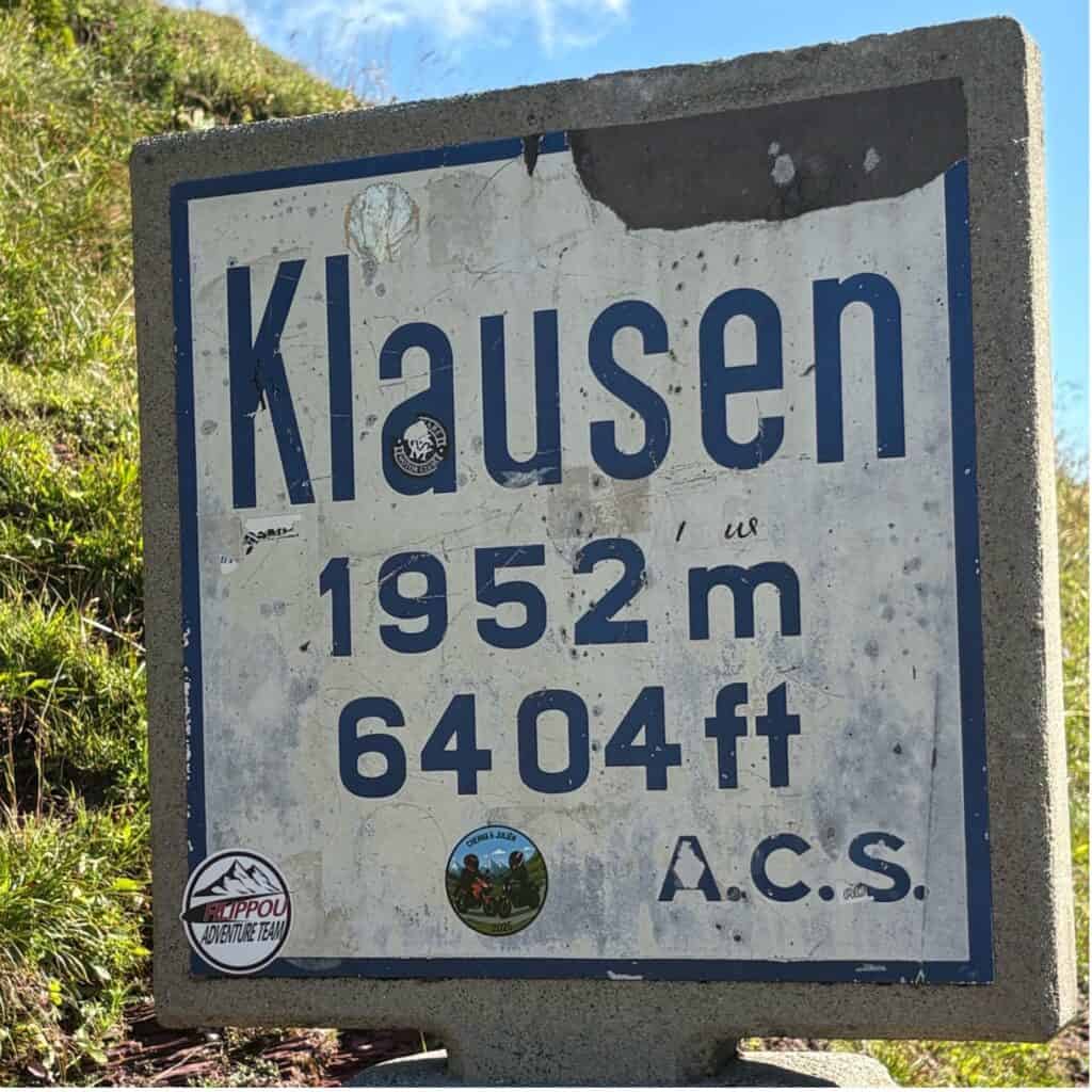 Klausenpass signpost showing altitude 1952 m (6404 ft) at Klausenpasshöhe, Switzerland.