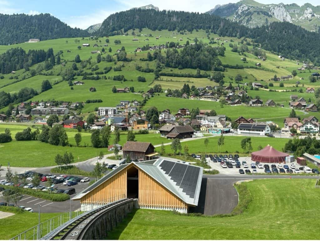 Modern Chäserrugg valley station with clean wooden architecture and solar panels on roof
