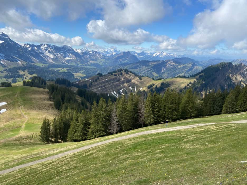 Snow-covered Alpine peaks viewed from Kronberg on a clear spring day. 