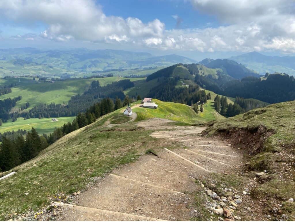 Hiking path descending from the Kronberg summit toward the Chapel of St. James