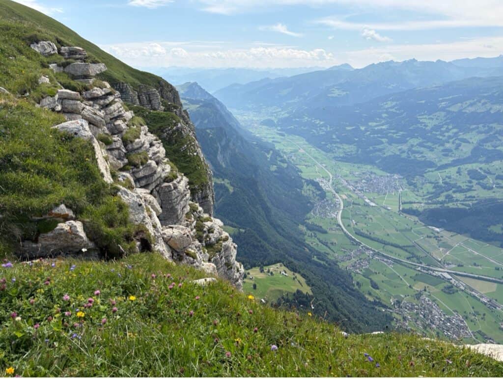 View from Chäserrugg overlooking the Rhine Valley with distant hills and settlements.