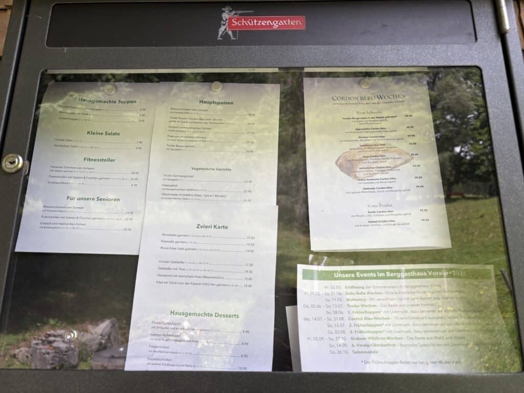Menu posted outside Berggasthaus Voralp showing traditional alpine dishes. 