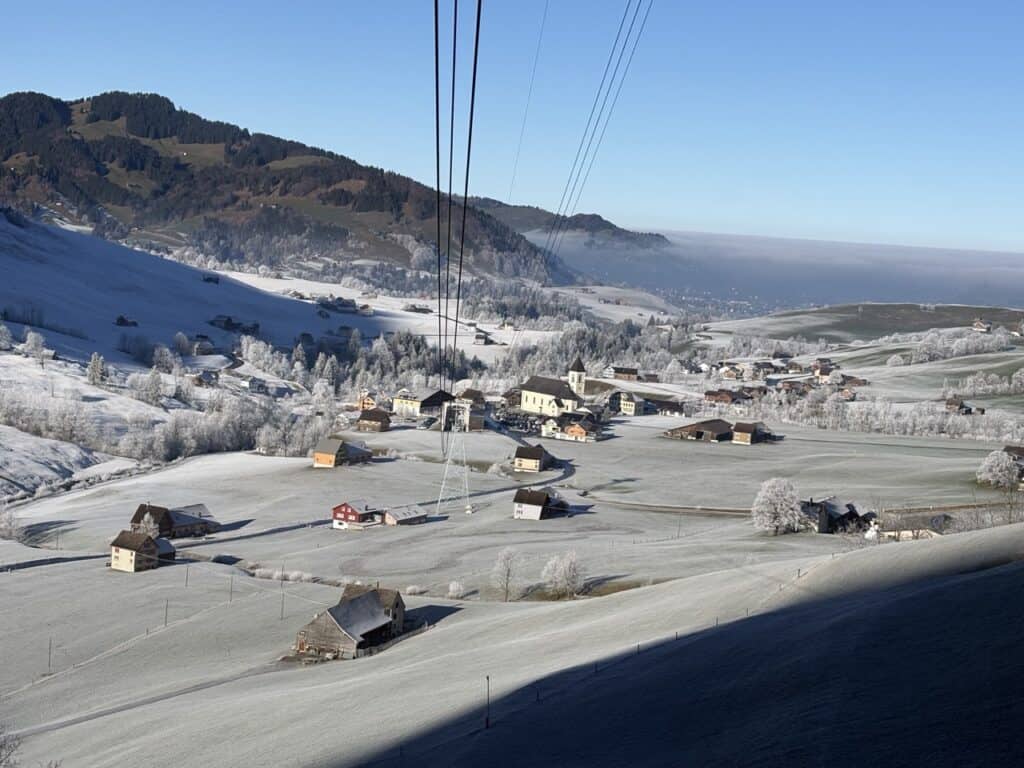 Aerial view of the frost-covered landscape around Brülisau seen from the Hoher Kasten cable car. 

