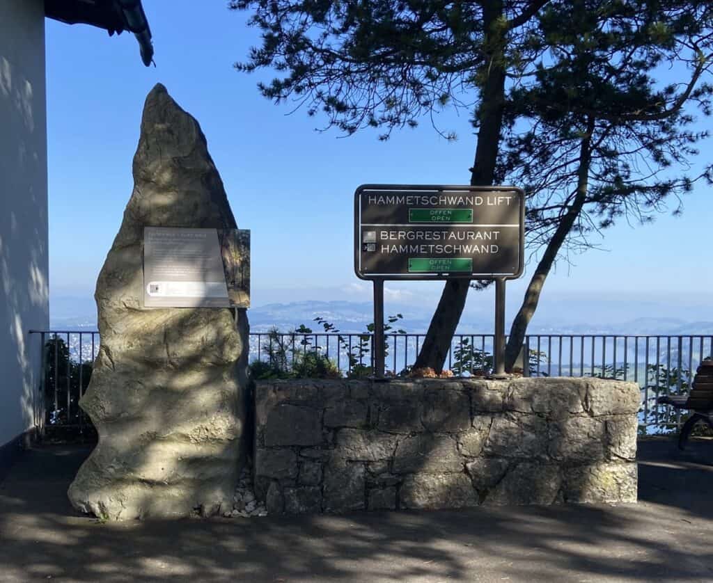 Start of the Felsenweg (Cliff Walk) on Bürgenstock with green signs showing the Hammetschwand Lift and mountain restaurant are open.