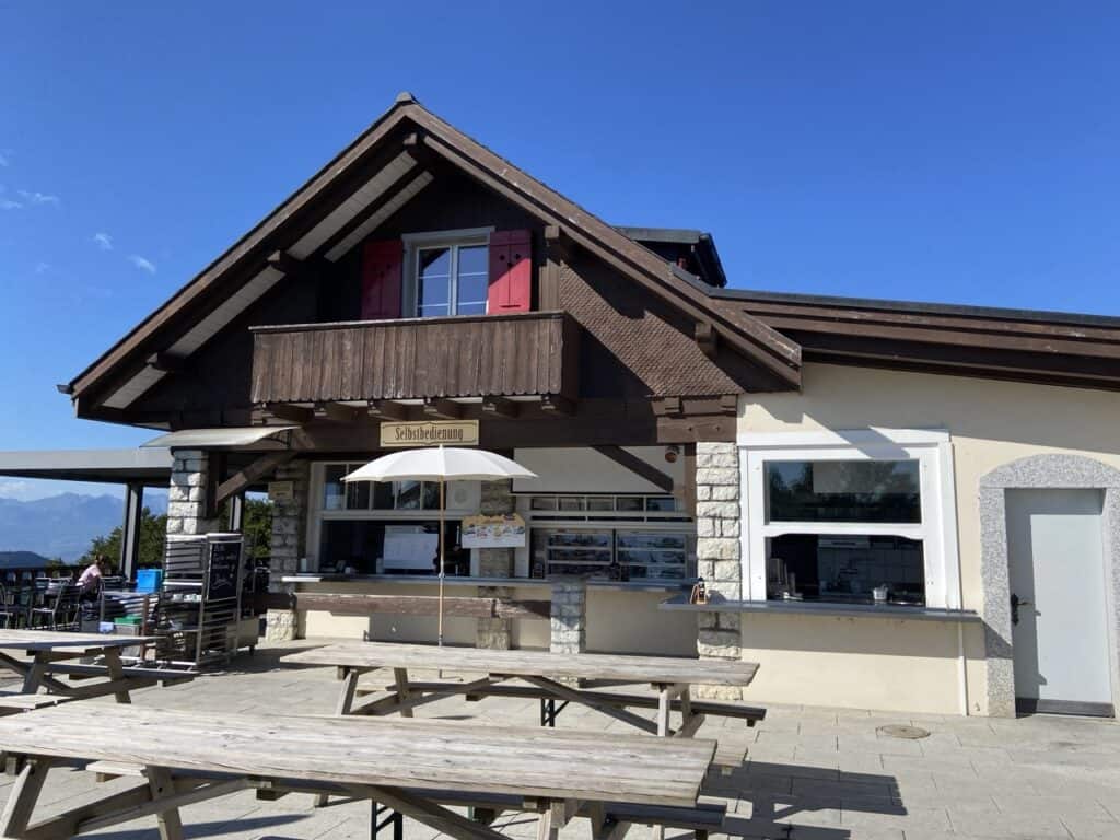 Bergrestaurant Hammetschwand, a chalet-type mountain restaurant with an outdoor seating area on a clear summer day.