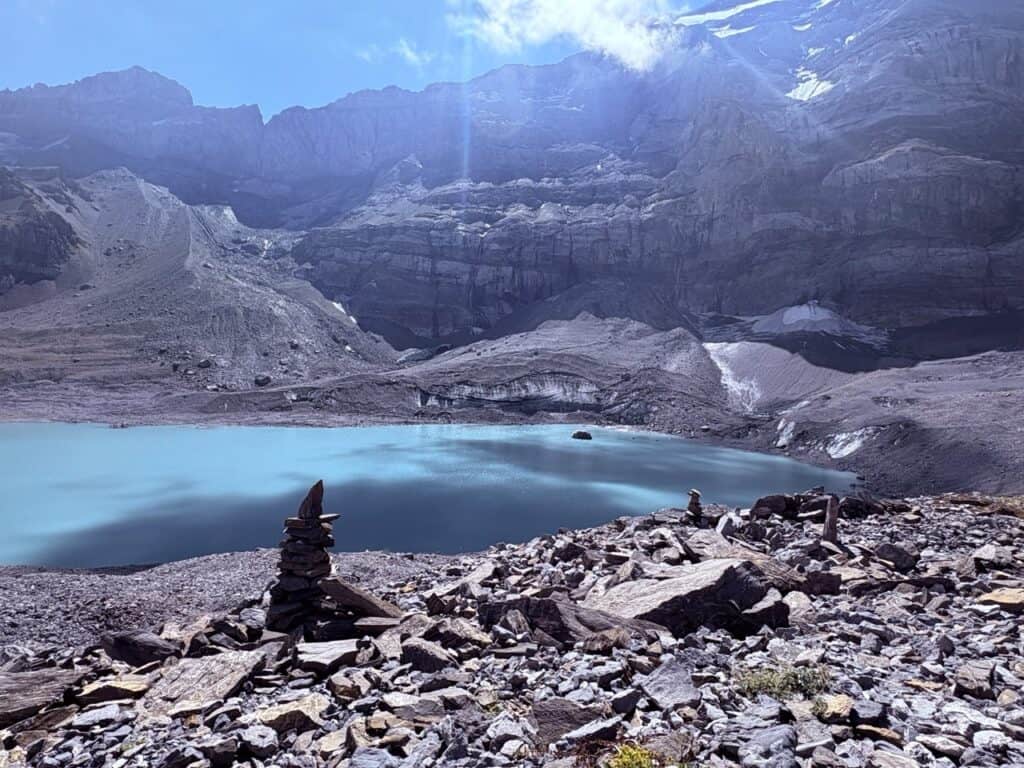 Gletscherseeli, a small glacier lake near Klausenpass, surrounded by rocky terrain and dramatic peaks resembling another planet,