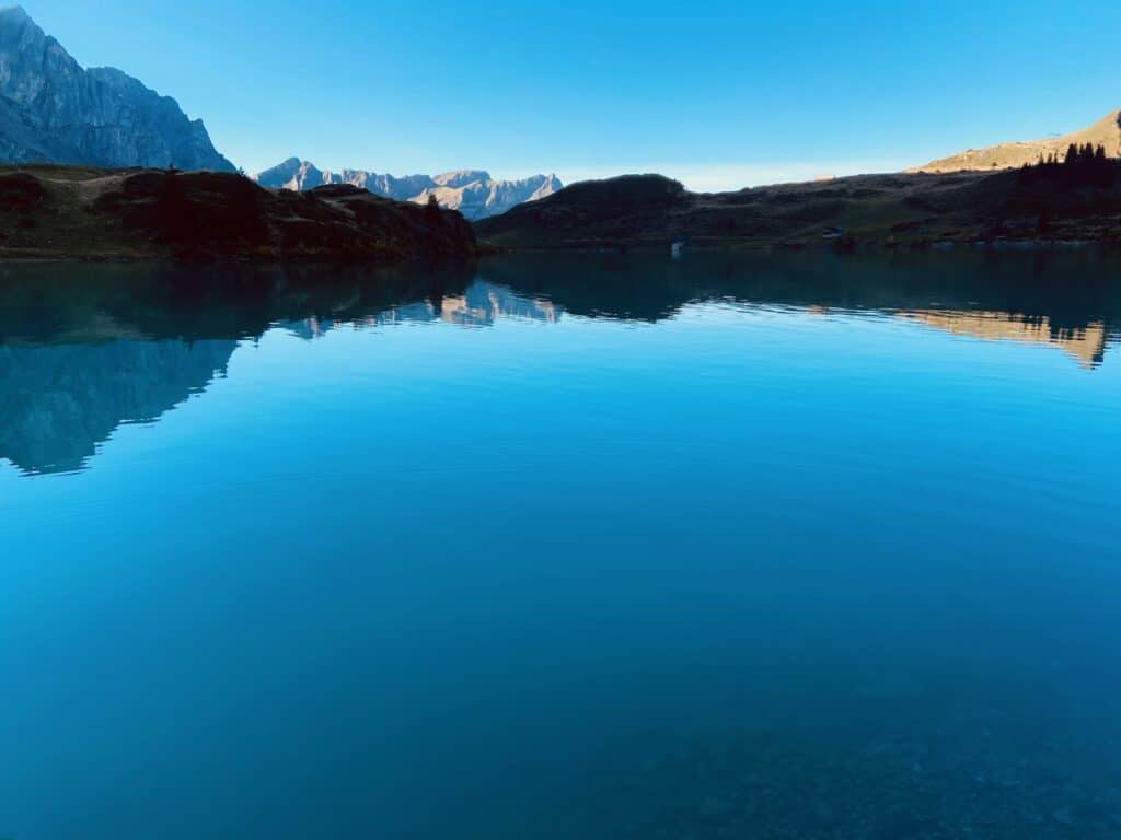 Panoramic view of the Alpine lake Trübsee at dusk. 