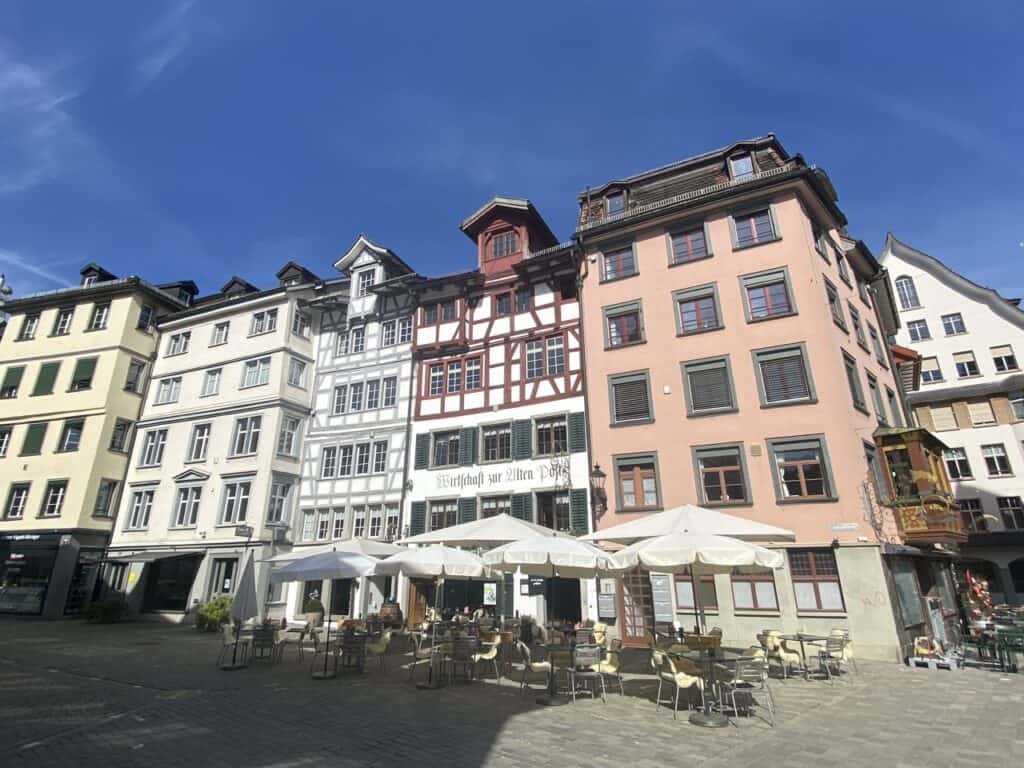 Historic Old Town St. Gallen with colorful buildings and restaurant with outdoor seating