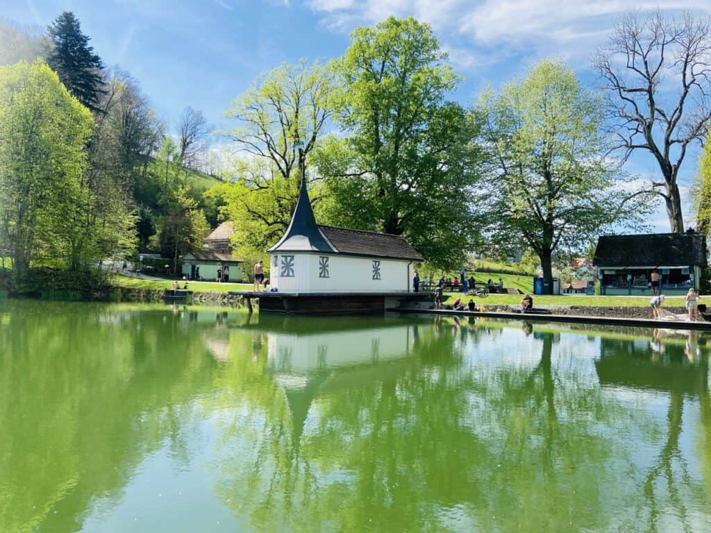 People relaxing at Drei Weihern ponds in St. Gallen Switzerland