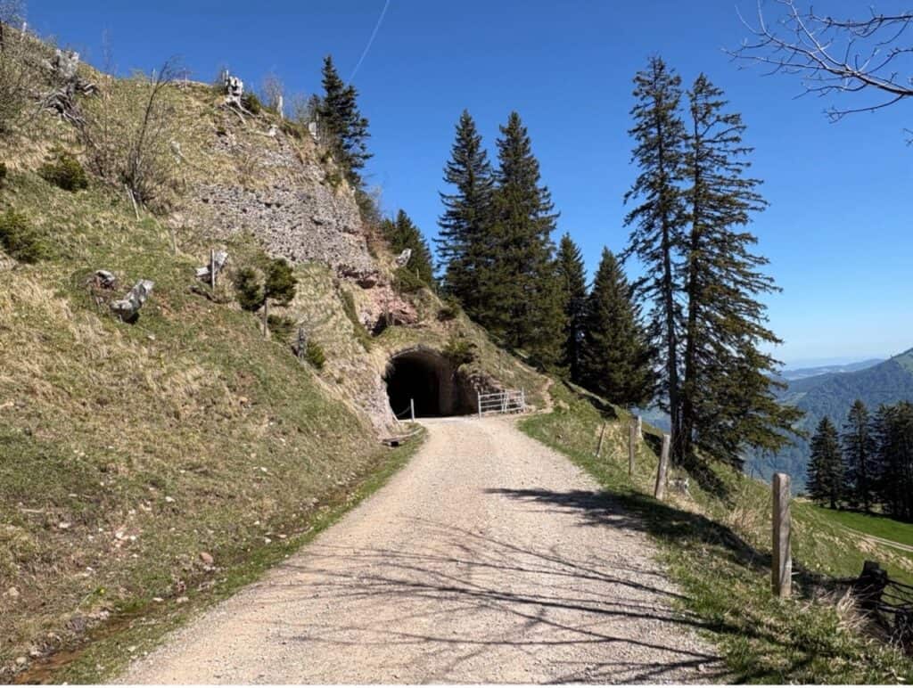 Panorama hiking trail passing through a historic railway tunnel on the route between Rigi Scheidegg and Rigi Kaltbad.
