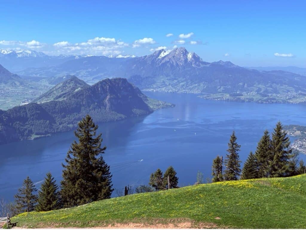 View from Panorama Hiking Trail of deep blue Lake Lucerne and Mount Pilatus.