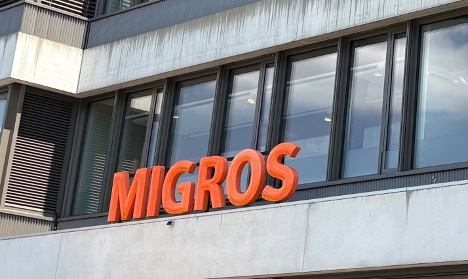 Orange Migros sign: Migros is the largest supermarket chain in Switzerland.
