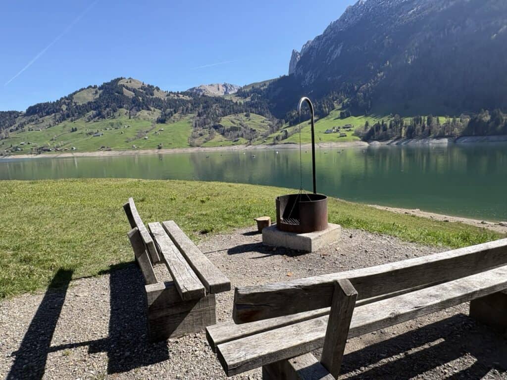 Barbecue area beside Wägitalersee lake surrounded by green hills