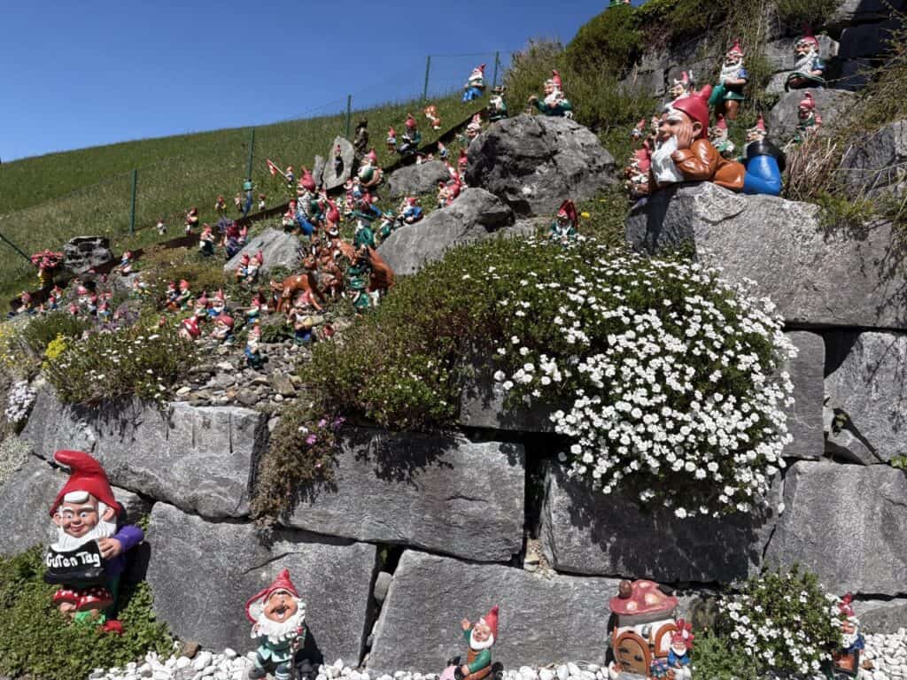 Colorful garden filled with garden gnomes near Wägitalersee lake