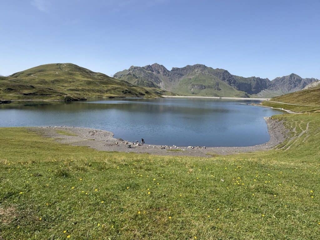 Beautiful Tannensee reservoir near Melchsee-Frutt, a peaceful alpine lake popular with fishermen along the Four Lakes Hike Switzerland.