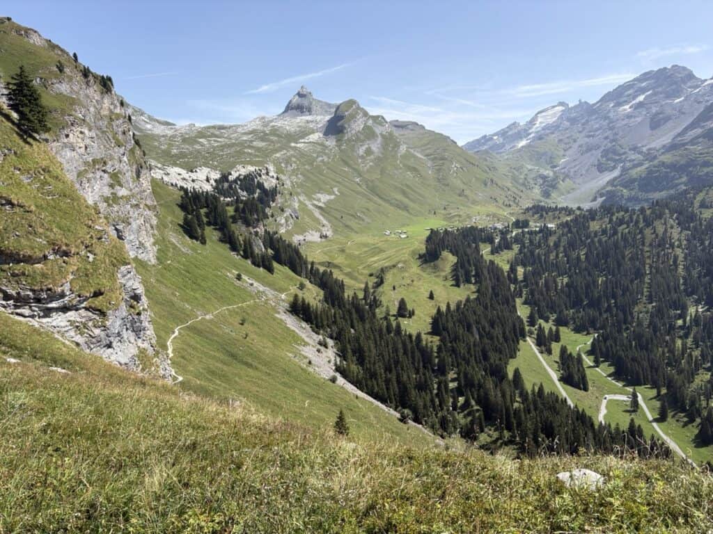 Stunning alpine landscape viewed from the hiking trail leading to Engstlenalp with Mount Titlis in the distance. 