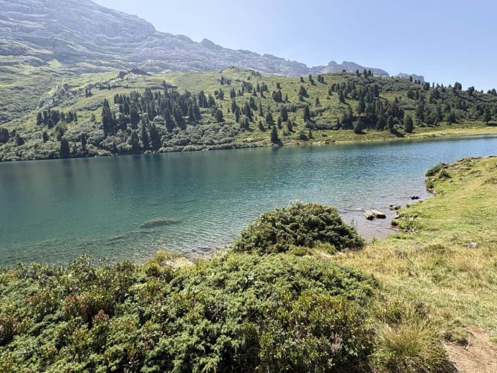 Stunning turquoise-blue Engstlensee surrounded by mountains, a peaceful place to relax and recharge while hiking in the Swiss Alps.